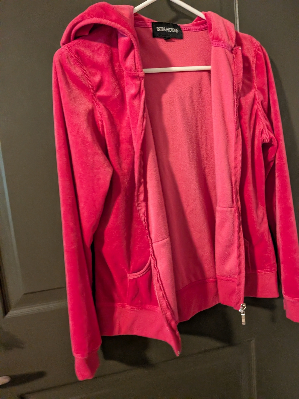 Beta House pink velour zip-up hoodie features a plush fabric and front pockets.